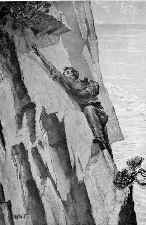 boy climbing cliff