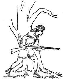 wilderness man holding rifle looking around tree